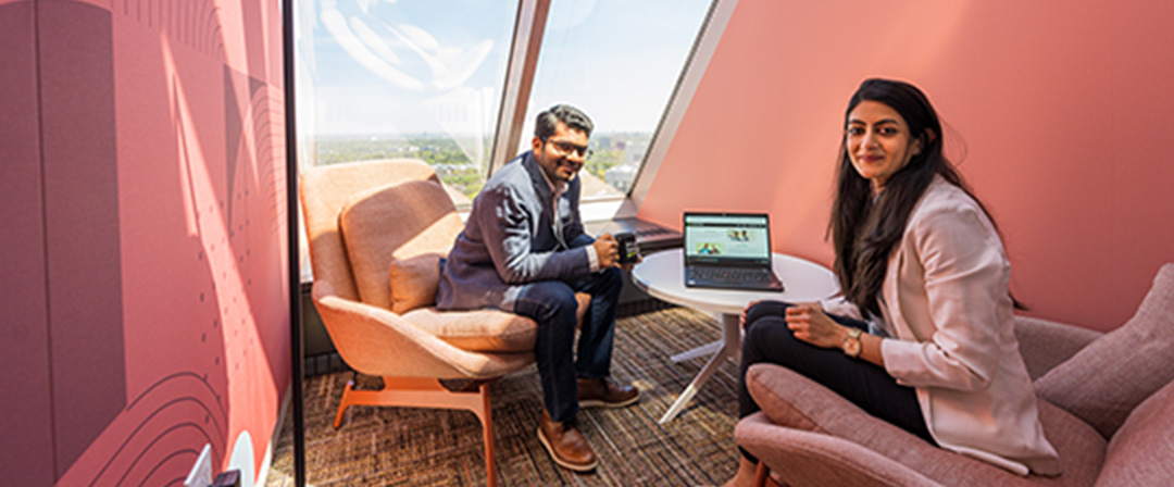 Two employees working and lounging at Questrade office