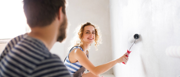 Couple painting a wall